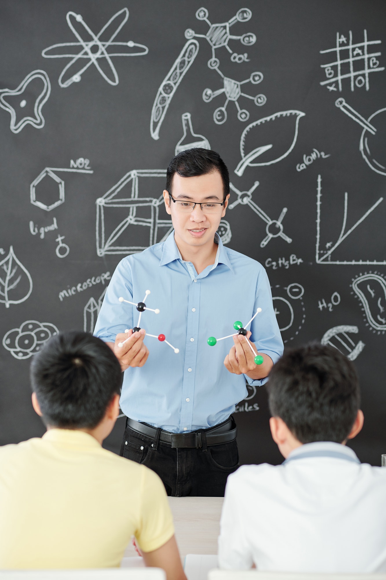 teacher-showing-molecular-models
