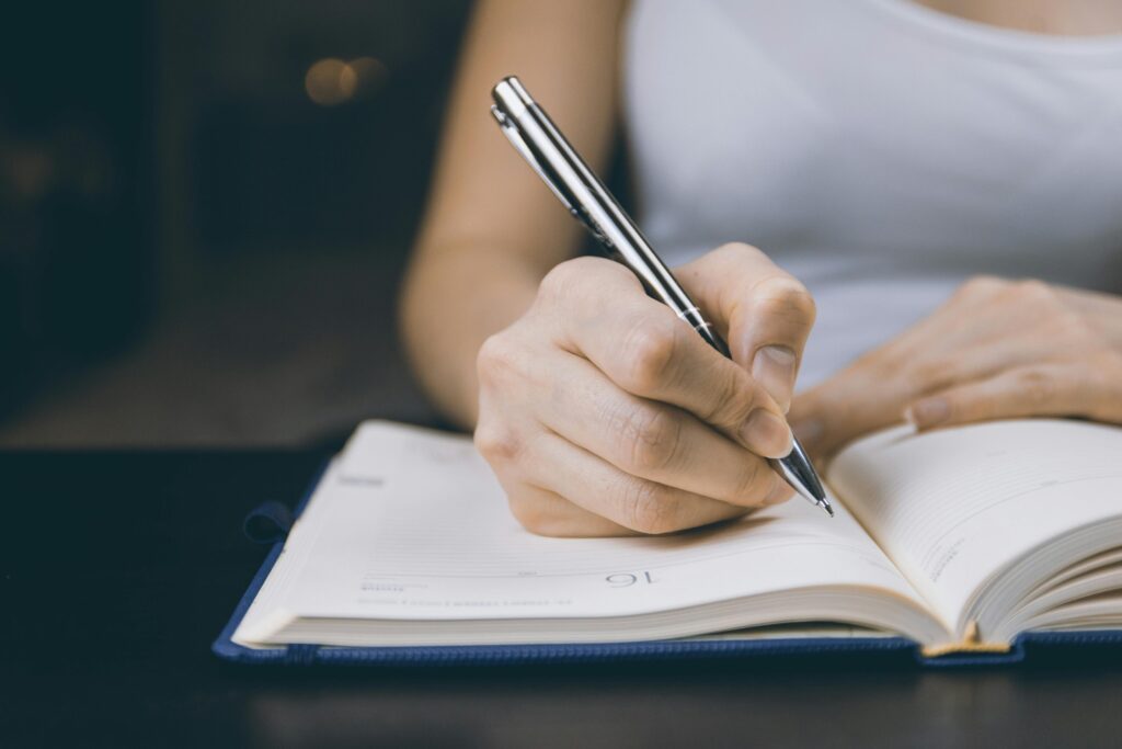 Hand-writing-notes-during-study-group-session