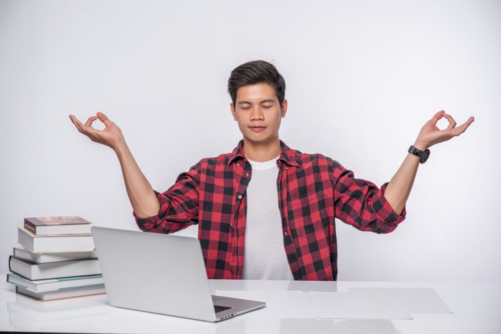 Student meditating to manage more pressure and stay focused