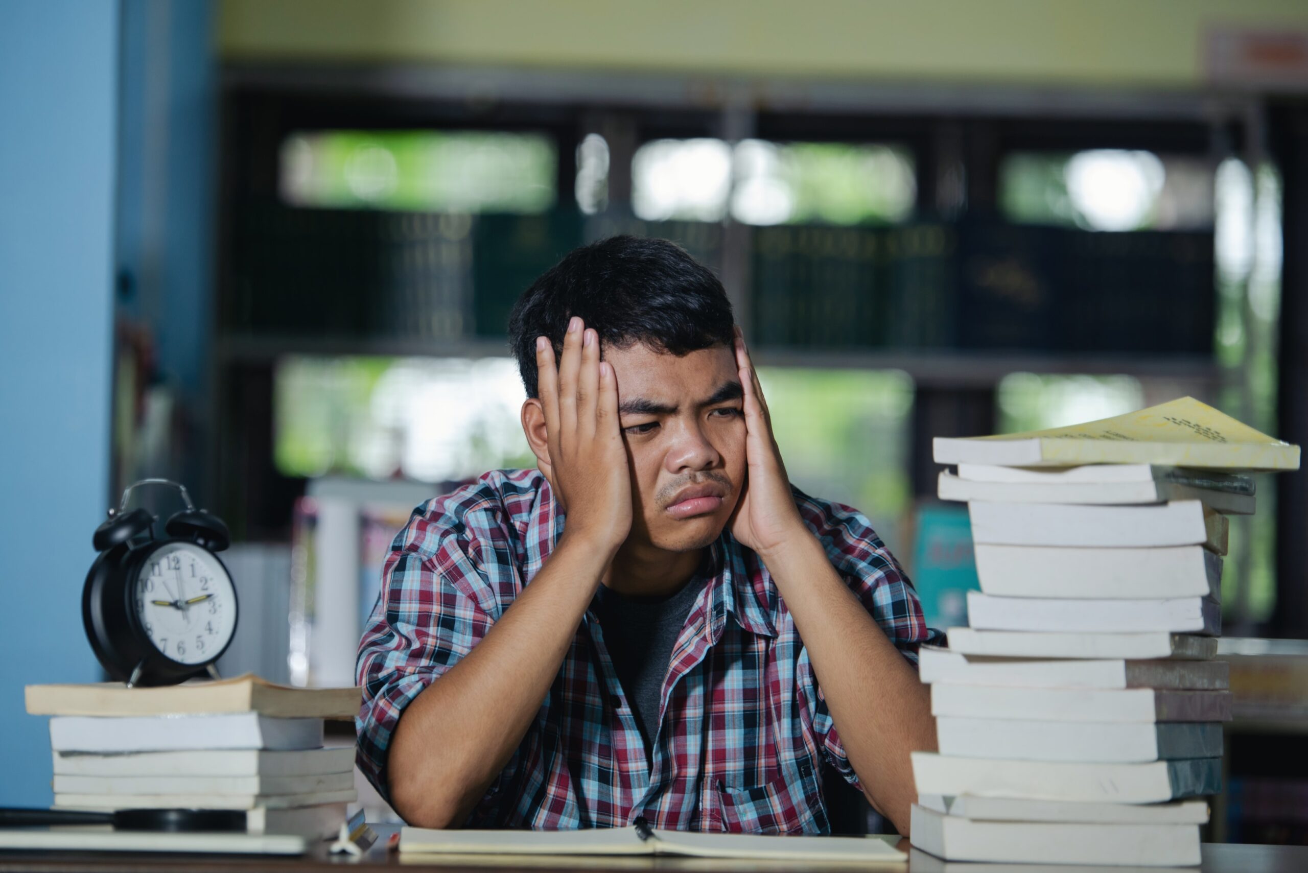Student showing signs of exam stress with a frown